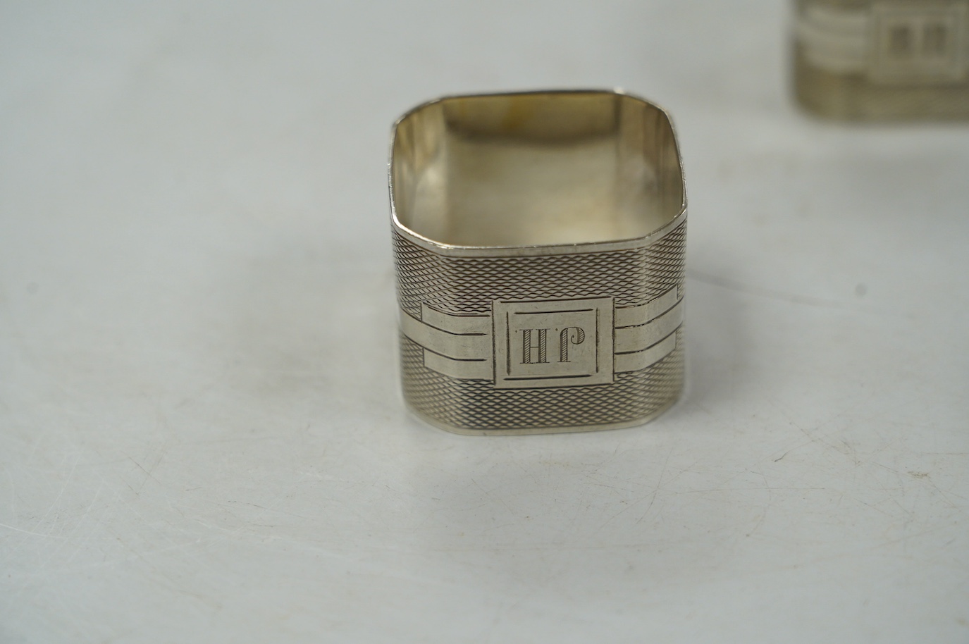 Eight assorted silver napkin rings, including a pair, Birmingham, 1937 and four plated napkin rings. Condition - fair